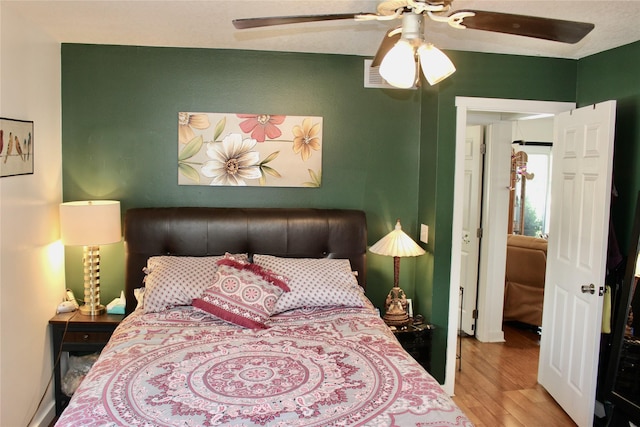 111 S 3rd Ave, Huxley, IA 50124 - bedroom featuring wood finished floors and a ceiling fan