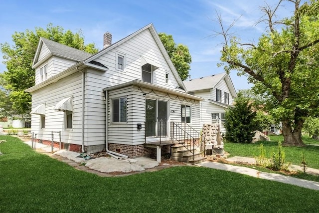 1236 York St, Des Moines, IA 50316 - rear view of house with a lawn and a chimney
