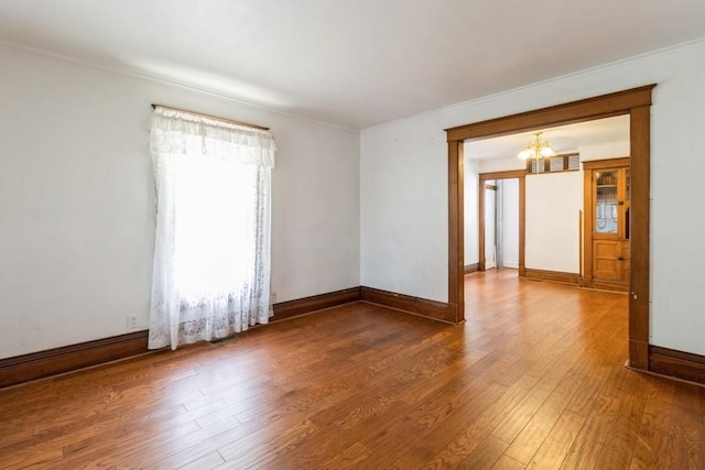 1236 York St, Des Moines, IA 50316 - spare room with a chandelier, hardwood / wood-style flooring, and crown molding
