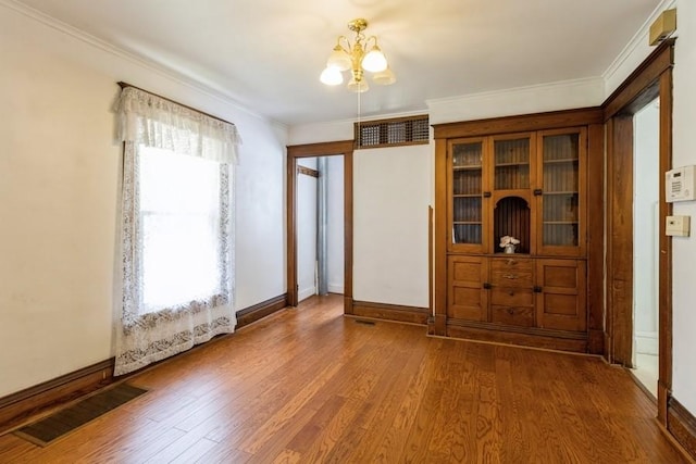 1236 York St, Des Moines, IA 50316 - foyer with a chandelier, wood finished floors, and ornamental molding