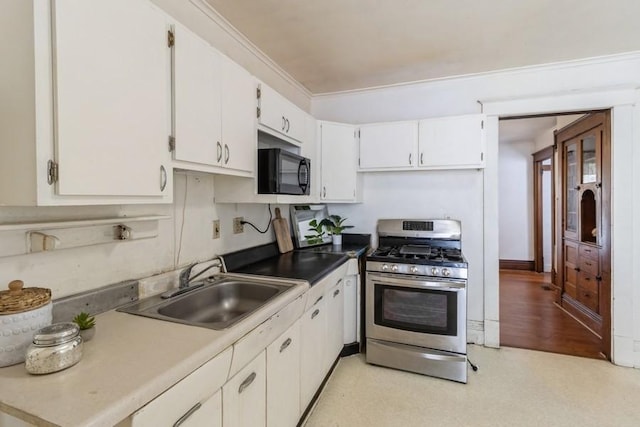 1236 York St, Des Moines, IA 50316 - kitchen with gas range, black microwave, and white cabinets