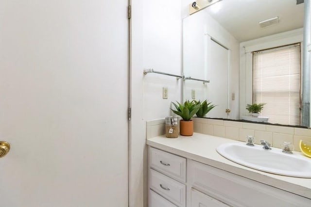 1236 York St, Des Moines, IA 50316 - bathroom with vanity and tasteful backsplash
