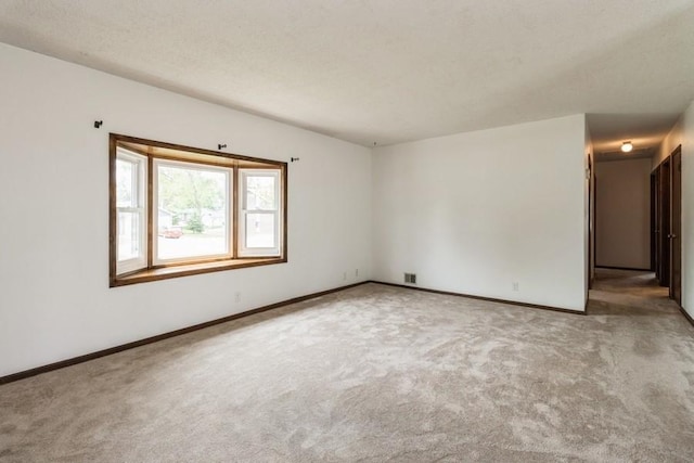 202 Harrison Ct, Baxter, IA 50028 - carpeted empty room with baseboards