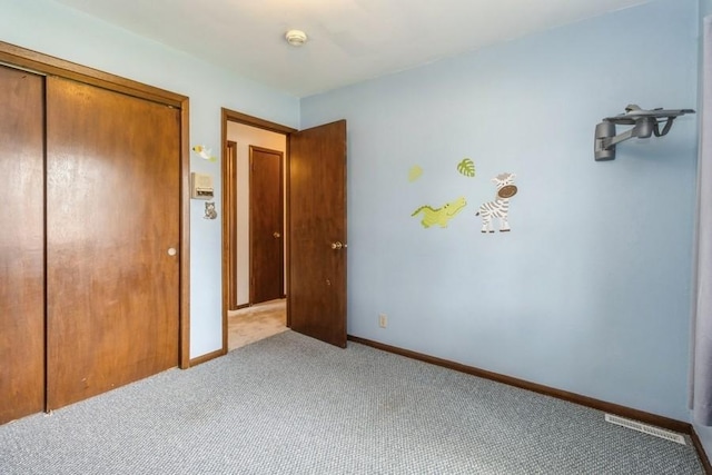 202 Harrison Ct, Baxter, IA 50028 - unfurnished bedroom featuring carpet and a closet