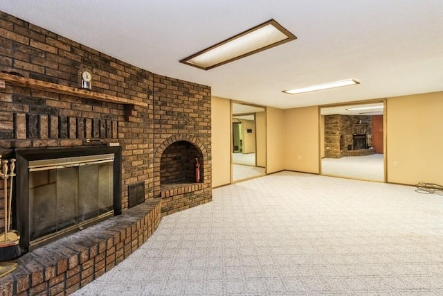 202 Harrison Ct, Baxter, IA 50028 - unfurnished living room with a fireplace and carpet floors