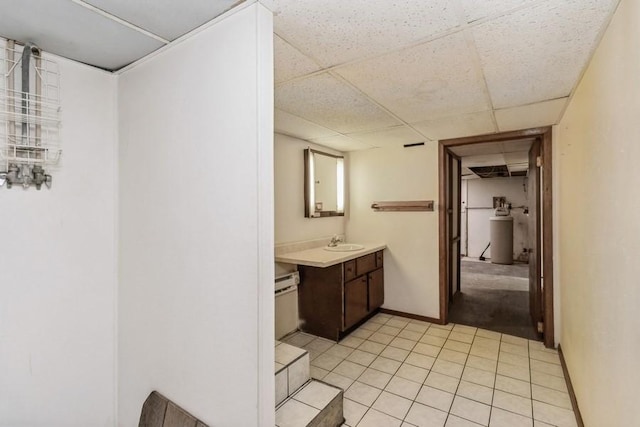 202 Harrison Ct, Baxter, IA 50028 - bathroom featuring vanity, a drop ceiling, and tile patterned flooring