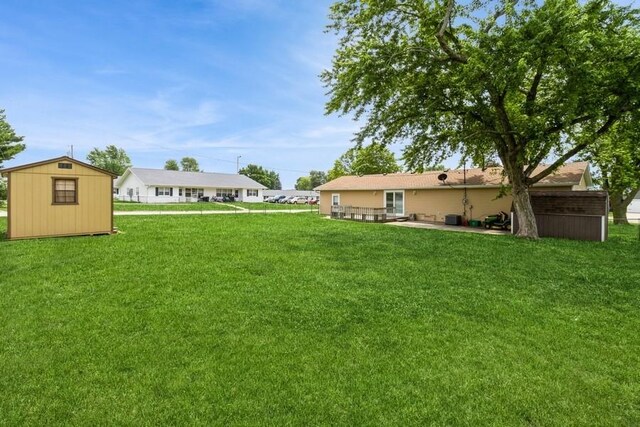 202 Harrison Ct, Baxter, IA 50028 - view of green lawn with a shed