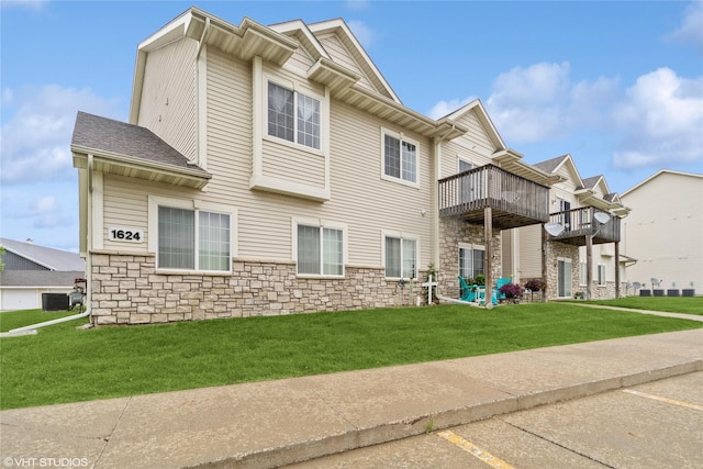 1624 NW Prairie Lakes Dr Unit 4, Ankeny, IA 50023 - view of front of property with stone siding, a front lawn, and uncovered parking