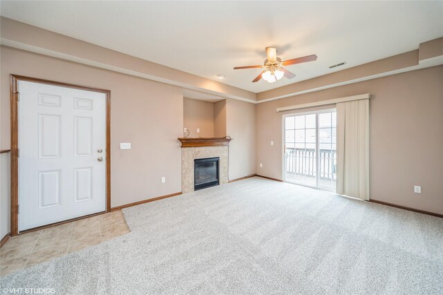 1624 NW Prairie Lakes Dr Unit 4, Ankeny, IA 50023 - unfurnished living room featuring ceiling fan, a tile fireplace, and light carpet