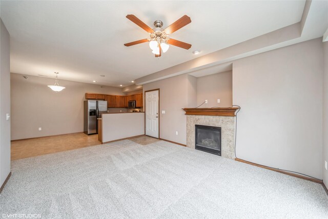 1624 NW Prairie Lakes Dr Unit 4, Ankeny, IA 50023 - unfurnished living room with ceiling fan, light colored carpet, recessed lighting, and a tiled fireplace