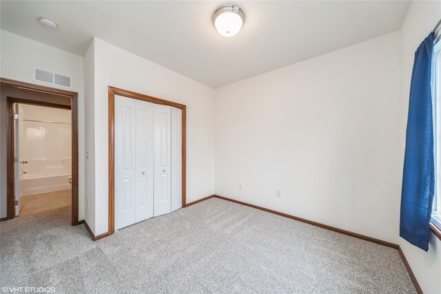 1624 NW Prairie Lakes Dr Unit 4, Ankeny, IA 50023 - unfurnished bedroom featuring light carpet and a closet