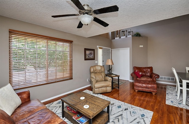 57 SE Meadowlark Ct, Waukee, IA 50263 - living room featuring a textured ceiling, ceiling fan, and wood finished floors