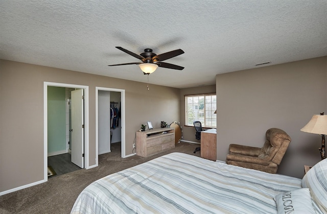 57 SE Meadowlark Ct, Waukee, IA 50263 - bedroom featuring dark carpet, a spacious closet, ceiling fan, an office area, and a closet