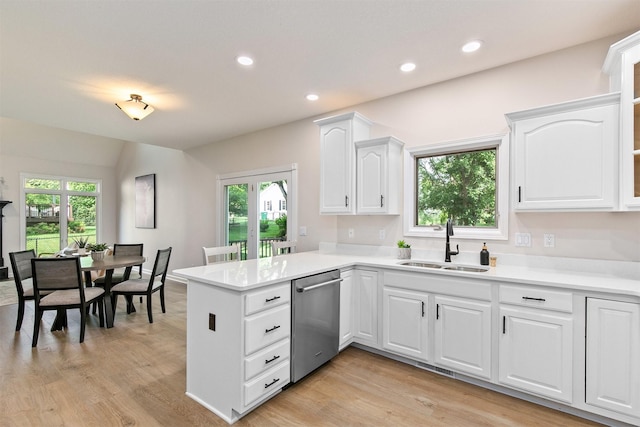 8151 Chambery Blvd, Johnston, IA 50131 - kitchen featuring stainless steel dishwasher, a peninsula, white cabinetry, light countertops, and plenty of natural light