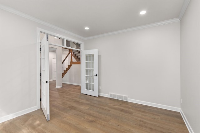 8151 Chambery Blvd, Johnston, IA 50131 - unfurnished bedroom featuring ornamental molding, wood finished floors, recessed lighting, and french doors
