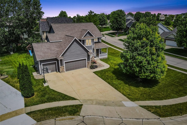 4108 158th Cir, Urbandale, IA 50323 - craftsman-style house with stone siding, concrete driveway, a garage, a front yard, and a shingled roof