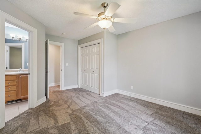 4108 158th Cir, Urbandale, IA 50323 - unfurnished bedroom featuring carpet floors, a closet, a textured ceiling, and a ceiling fan