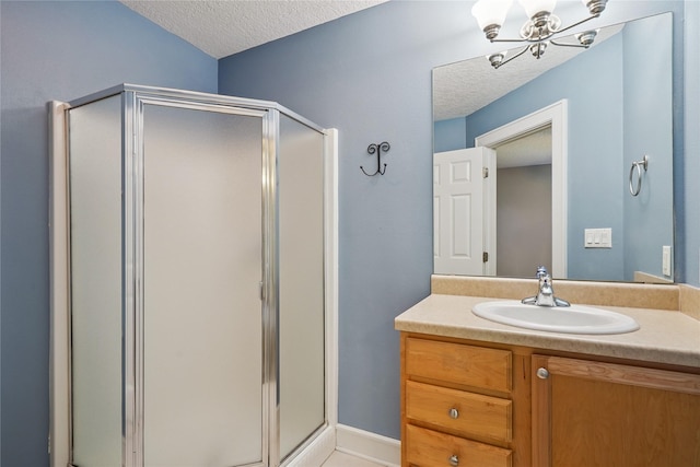 4108 158th Cir, Urbandale, IA 50323 - bathroom with a textured ceiling, a chandelier, a shower stall, and vanity