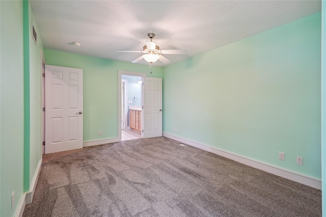 4108 158th Cir, Urbandale, IA 50323 - unfurnished bedroom with carpet, ensuite bathroom, a textured ceiling, and a ceiling fan