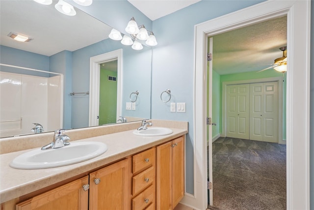 4108 158th Cir, Urbandale, IA 50323 - bathroom featuring double vanity, ceiling fan, and a shower