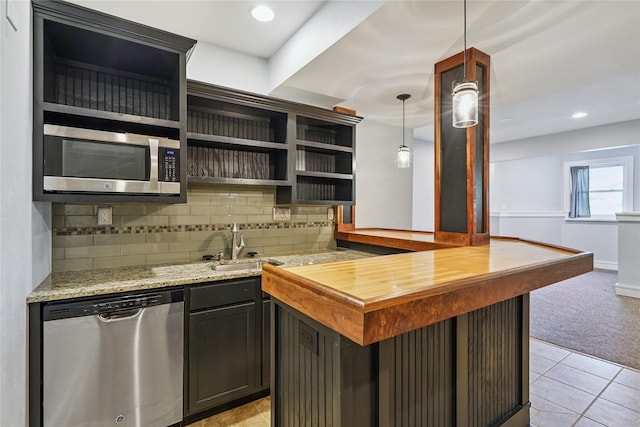 4108 158th Cir, Urbandale, IA 50323 - kitchen featuring appliances with stainless steel finishes, decorative backsplash, open shelves, light stone counters, and light carpet