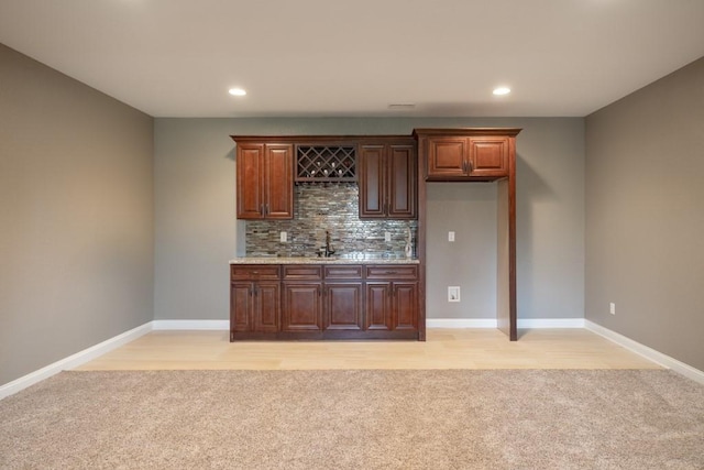655 NE Dellwood Dr, Waukee, IA 50263 - indoor wet bar featuring light colored carpet, backsplash, and recessed lighting