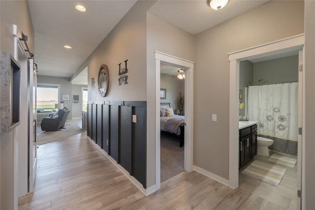 3210 NE 17th St, Ankeny, IA 50021 - hall with a barn door, light wood-style flooring, and recessed lighting