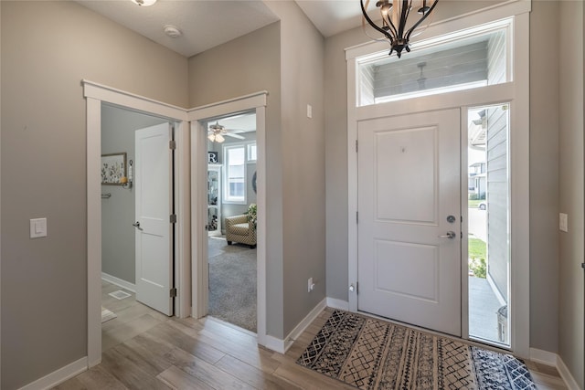 3210 NE 17th St, Ankeny, IA 50021 - foyer with light wood-style flooring, healthy amount of natural light, a chandelier, and ceiling fan