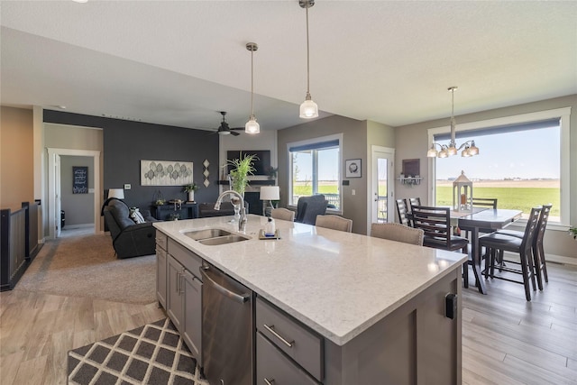 3210 NE 17th St, Ankeny, IA 50021 - kitchen with dishwasher, open floor plan, a chandelier, light wood-type flooring, and ceiling fan