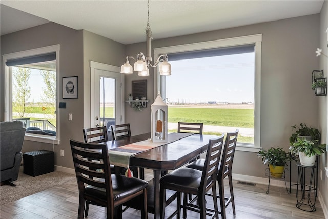 3210 NE 17th St, Ankeny, IA 50021 - dining room with light wood-style flooring and a chandelier