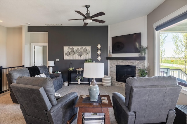 3210 NE 17th St, Ankeny, IA 50021 - living room with ceiling fan, carpet, and a stone fireplace