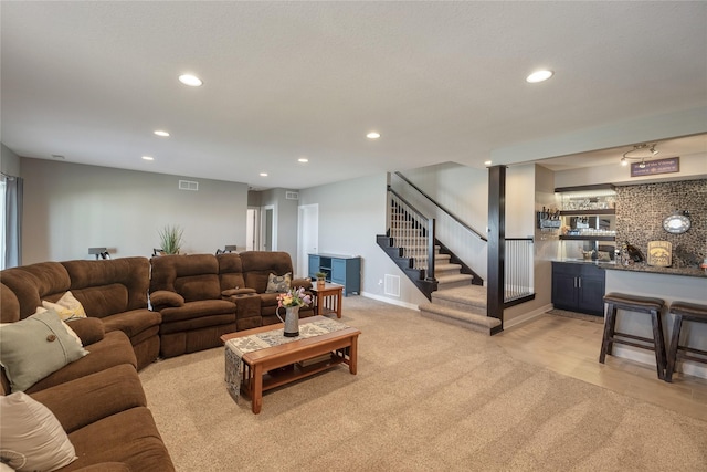 3210 NE 17th St, Ankeny, IA 50021 - living room with stairway, wet bar, recessed lighting, and light carpet