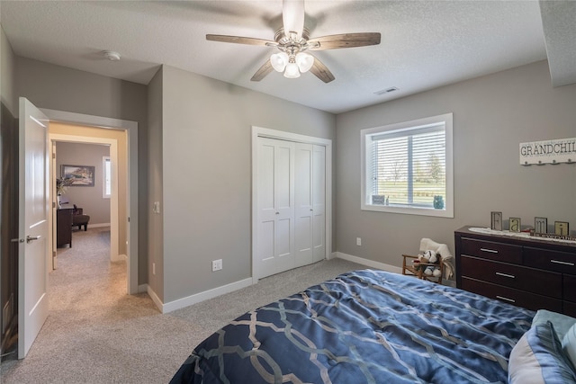3210 NE 17th St, Ankeny, IA 50021 - bedroom with light carpet, a textured ceiling, a closet, and a ceiling fan