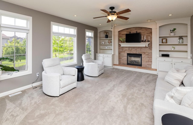 12602 Winston Ave, Urbandale, IA 50323 - living area featuring light carpet, a fireplace, healthy amount of natural light, and recessed lighting