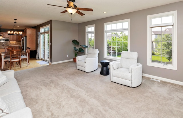 12602 Winston Ave, Urbandale, IA 50323 - living room featuring a chandelier, a ceiling fan, recessed lighting, and light carpet