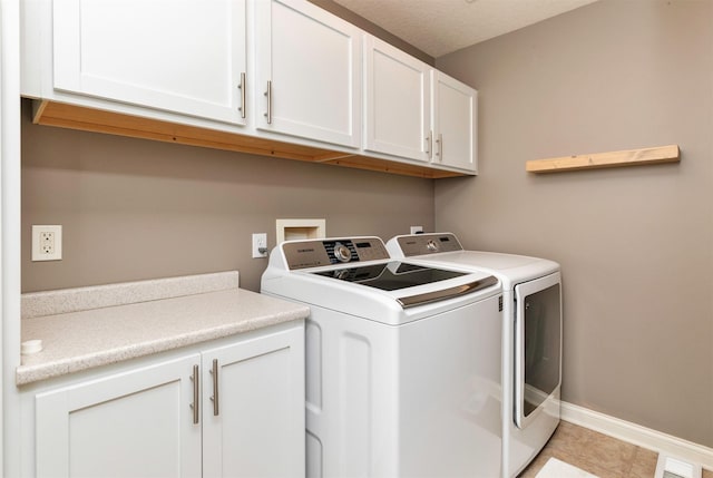 12602 Winston Ave, Urbandale, IA 50323 - laundry room featuring cabinet space, washer and dryer, and light tile patterned flooring