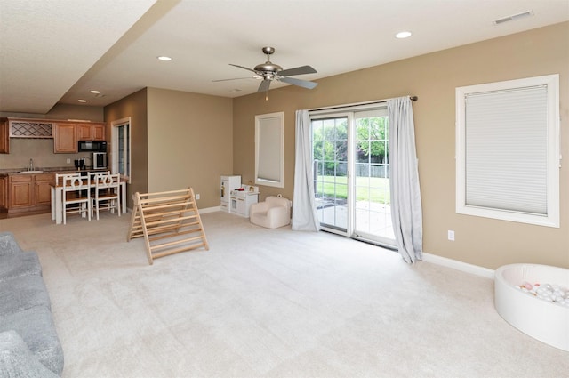 12602 Winston Ave, Urbandale, IA 50323 - living area featuring light colored carpet, recessed lighting, and a ceiling fan