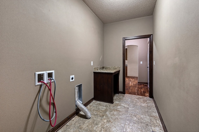 300 NW Sunset Ln, Grimes, IA 50111 - laundry area with electric dryer hookup, washer hookup, a textured ceiling, and arched walkways