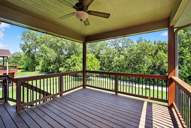 300 NW Sunset Ln, Grimes, IA 50111 - wooden deck with ceiling fan, a fenced backyard, and view of wooded area
