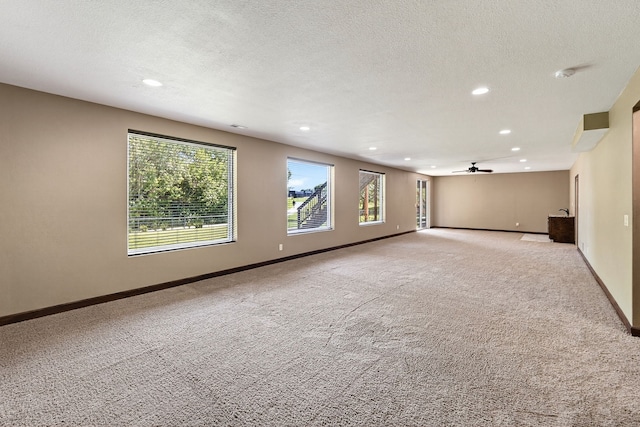 300 NW Sunset Ln, Grimes, IA 50111 - empty room with recessed lighting, light colored carpet, a ceiling fan, and a textured ceiling