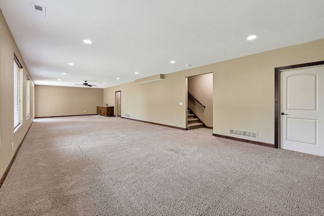 300 NW Sunset Ln, Grimes, IA 50111 - carpeted spare room with ceiling fan, recessed lighting, and stairs