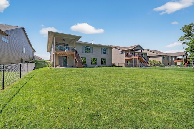 300 NW Sunset Ln, Grimes, IA 50111 - back of property featuring stairs, a fenced backyard, ceiling fan, and a balcony