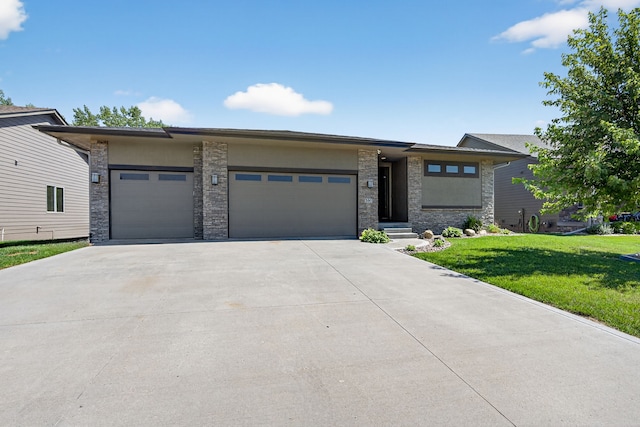 300 NW Sunset Ln, Grimes, IA 50111 - prairie-style house with an attached garage, a front lawn, driveway, and stone siding