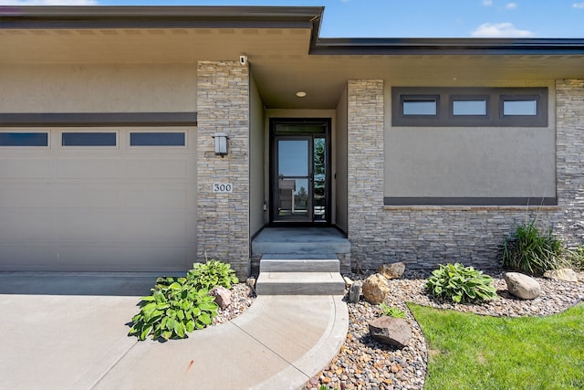 300 NW Sunset Ln, Grimes, IA 50111 - property entrance featuring stone siding, stucco siding, and driveway