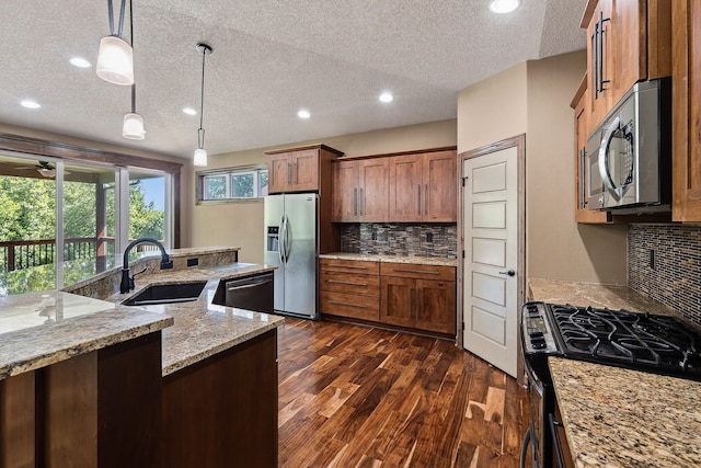 300 NW Sunset Ln, Grimes, IA 50111 - kitchen with appliances with stainless steel finishes, a textured ceiling, dark wood-style flooring, recessed lighting, and brown cabinets
