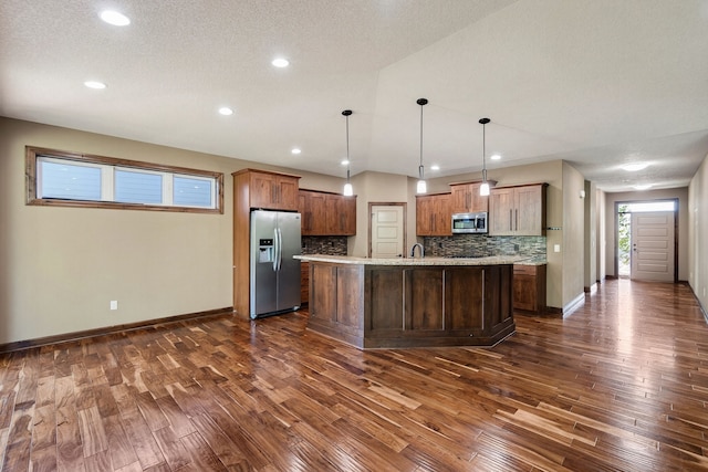 300 NW Sunset Ln, Grimes, IA 50111 - kitchen with appliances with stainless steel finishes, dark wood-style flooring, decorative backsplash, a center island with sink, and recessed lighting