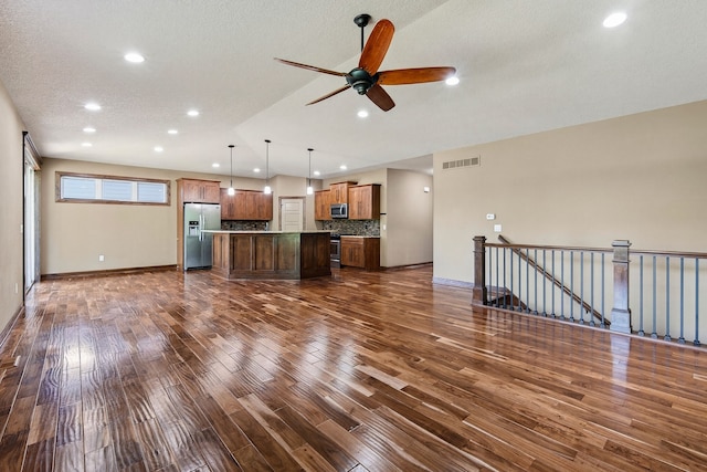 300 NW Sunset Ln, Grimes, IA 50111 - unfurnished living room with dark wood-type flooring, recessed lighting, ceiling fan, and a textured ceiling