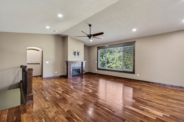 300 NW Sunset Ln, Grimes, IA 50111 - unfurnished living room featuring a ceiling fan, a textured ceiling, wood finished floors, a glass covered fireplace, and recessed lighting