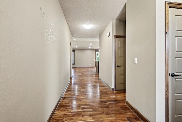 300 NW Sunset Ln, Grimes, IA 50111 - hallway with dark wood-style flooring and a textured ceiling