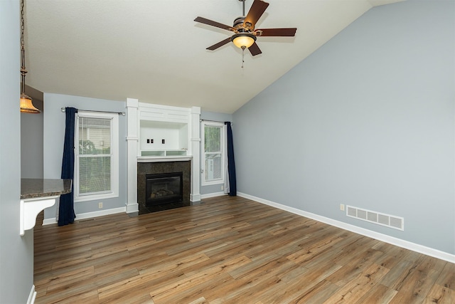 1736 Ashwood Dr SW, Altoona, IA 50009 - unfurnished living room with lofted ceiling, wood finished floors, ceiling fan, and a high end fireplace